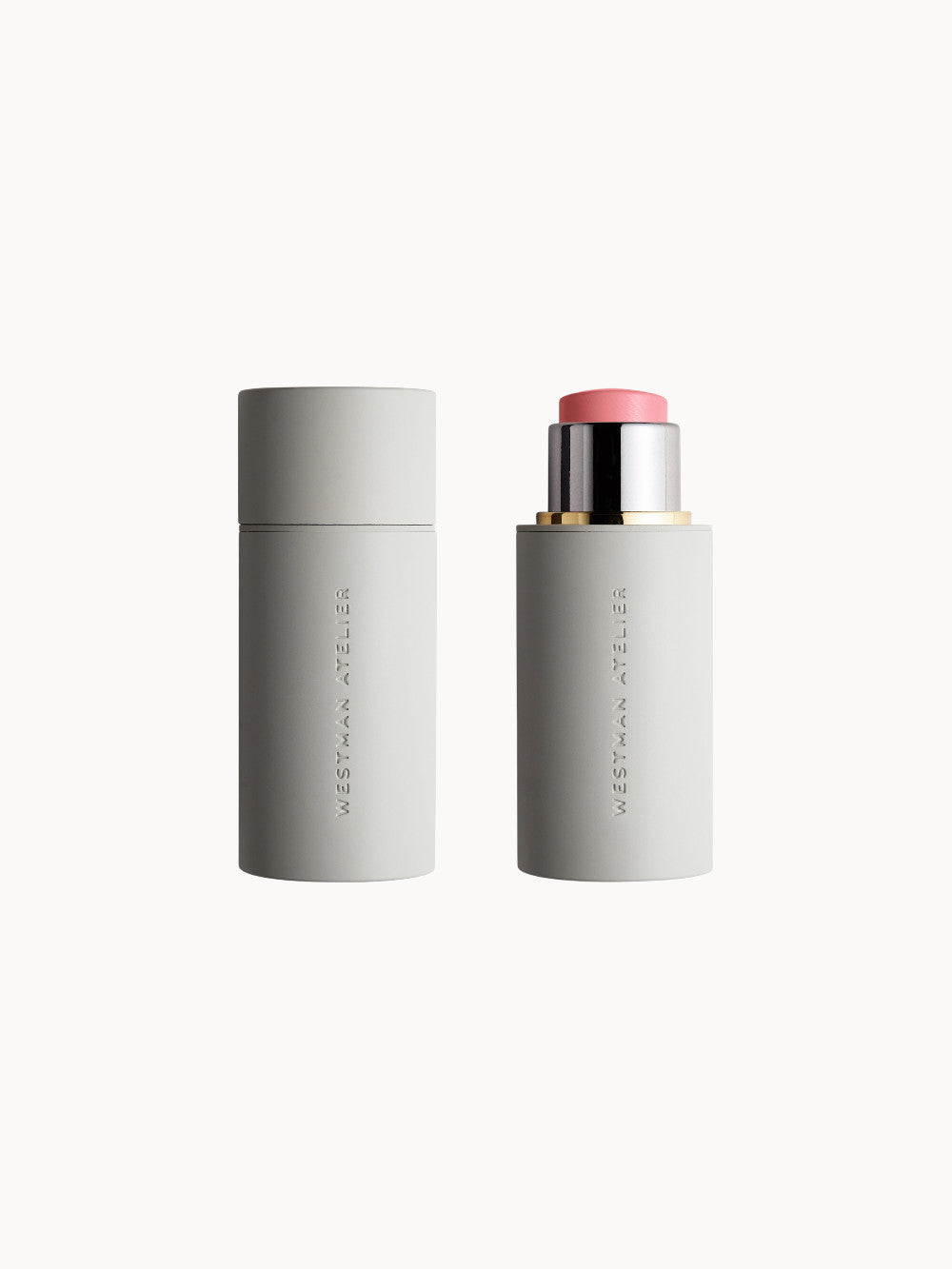 Creme-Rougestift in hellem Rosa von Westman Atelier, mit geöffneter und geschlossener Kappe nebeneinander vor weißem Hintergrund.